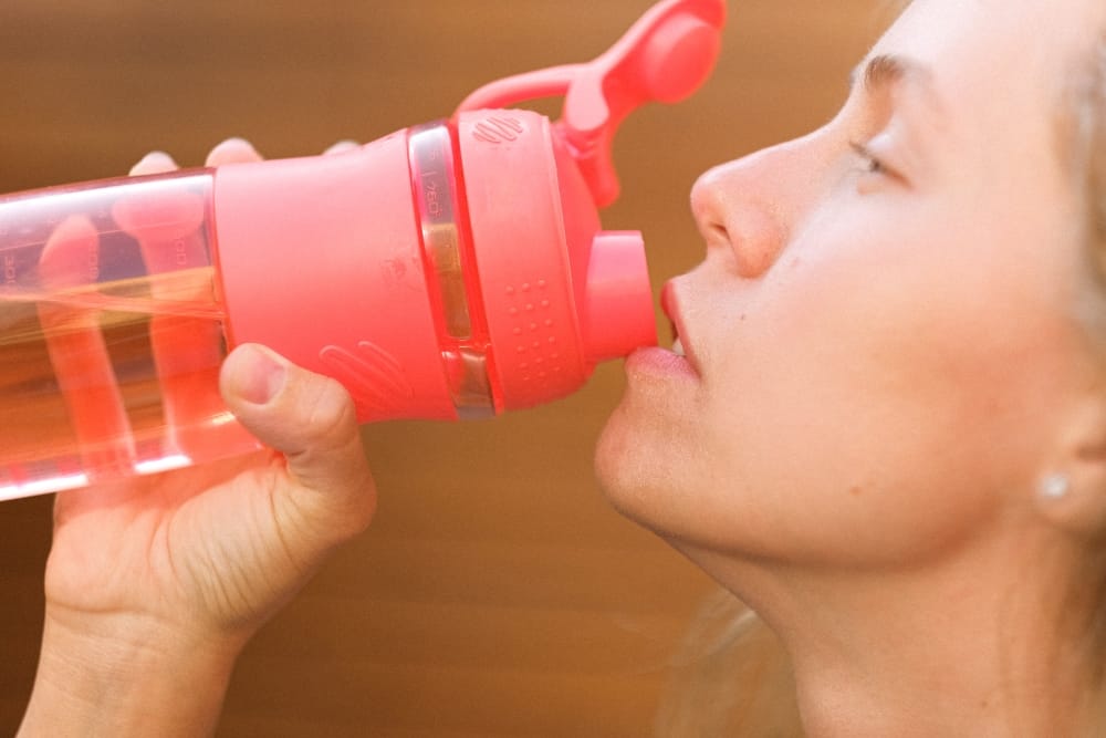 A Girl doing Her Daily hydration Routine by Sipping Water